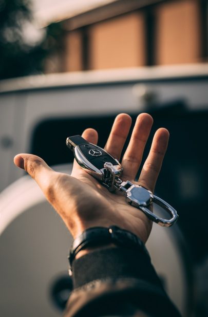 person holding Mercedes-Benz fob