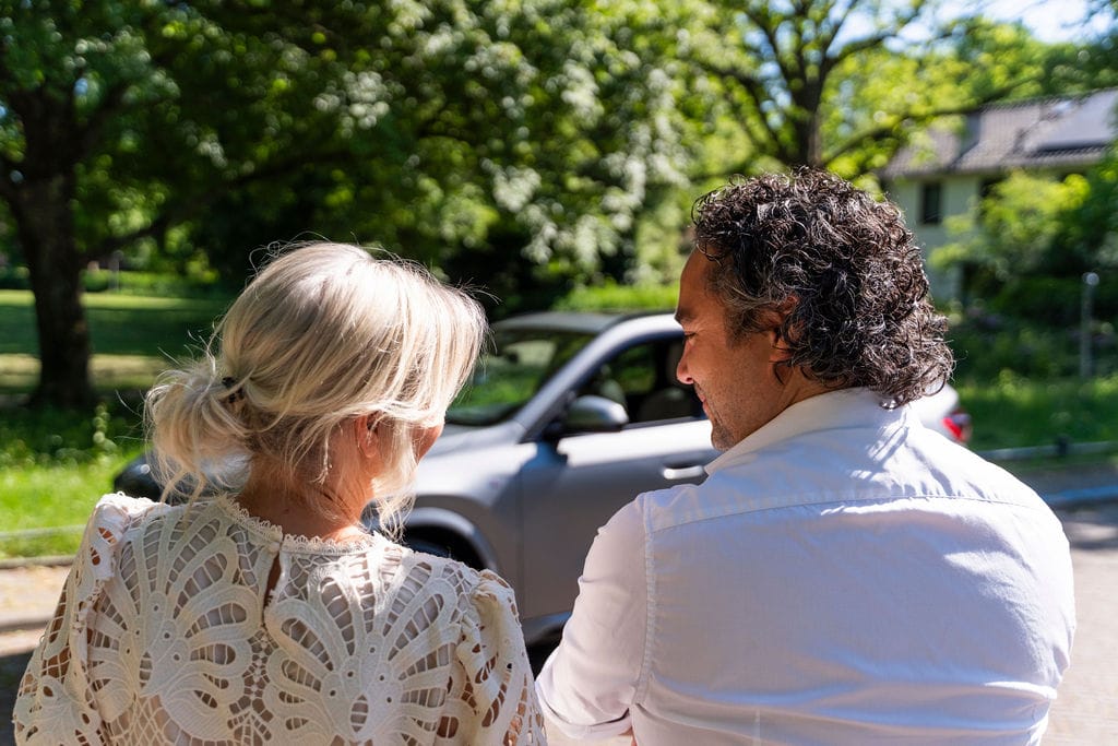 Stel kijkt samen naar hun nieuwe auto